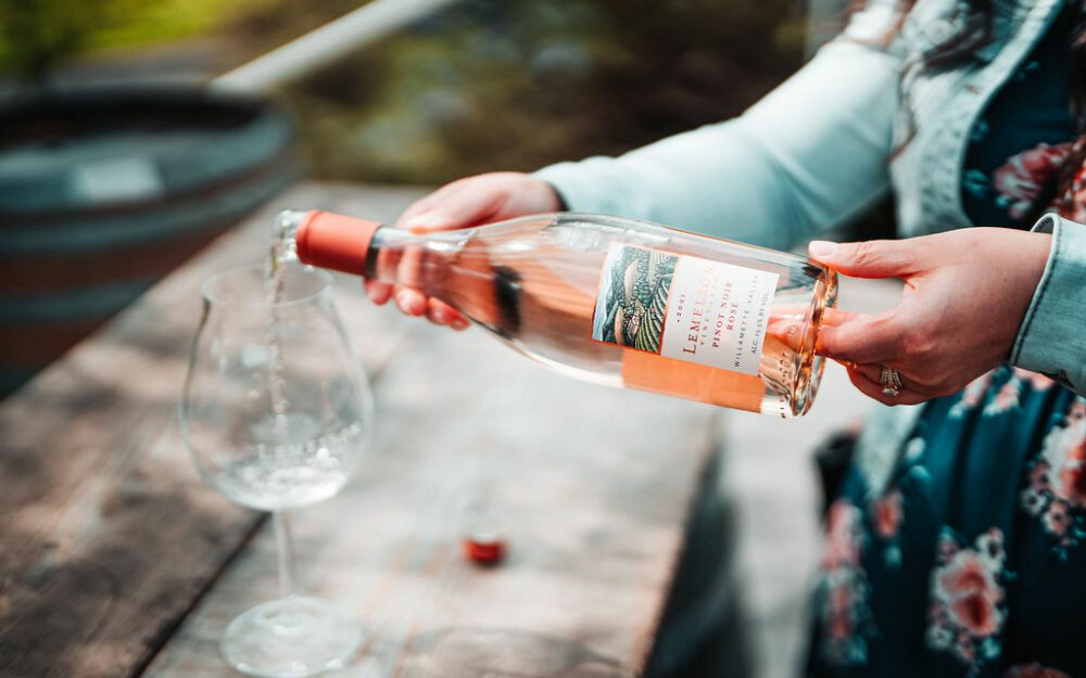 Woman pouring Lemelson Rosé into a glass